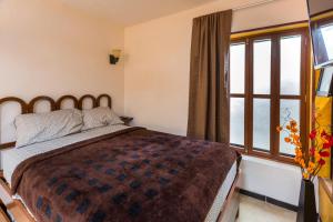 Postel nebo postele na pokoji v ubytování Merida Serviced Apartments