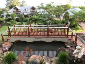 
a walkway leading to a garden with a bench at Clarence River Bed & Breakfast in Grafton
