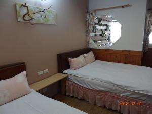 Voodi või voodid majutusasutuse Shan Shui-Yuan Vege Guest House toas