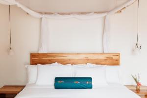 a bed with a blue bag sitting on top of it at The Retreat in Kigali