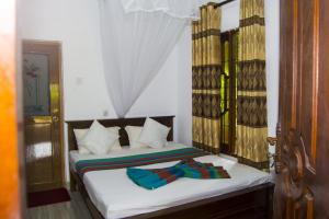 Ένα ή περισσότερα κρεβάτια σε δωμάτιο στο Sigiri Star Homestay