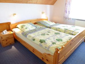 two beds in a bedroom with a wooden bed frame at Apartment Bentweg by Interhome in Altgaude