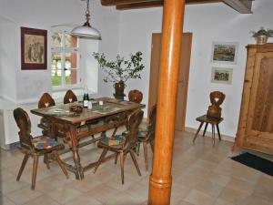 a dining room with a wooden table and chairs at Apartment Kunstmühle by Interhome in Dienstedt-Hettstedt