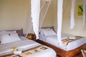 Postel nebo postele na pokoji v ubytování Ichumbi Gorilla Lodge