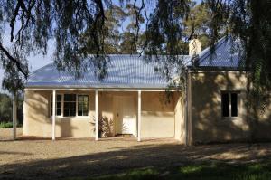 a white house with a white garage at Peppermint Farm Cottage in McLaren Vale