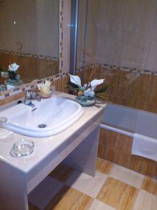 a bathroom with a white sink and a shower at Hotel Mirador in Algeciras