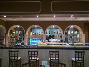 a bar with chairs and bottles of alcohol at Hotel Mirador in Algeciras
