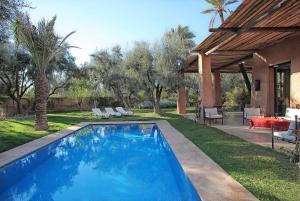 a swimming pool in the yard of a house at Lankah - Authentic villa with private heated pool close to city center in Douar Caïd Layadi