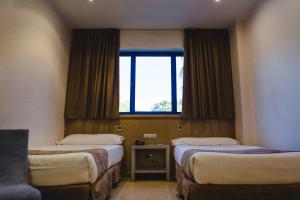 Postel nebo postele na pokoji v ubytování Hotel Mas Camarena