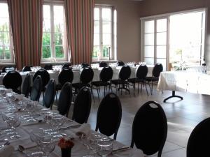 
a room filled with chairs and tables filled with chairs at Hostellerie d'Héloïse in Cluny
