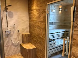 a sauna with a shower and a bench in a room at Klassik Appartements in Helgoland