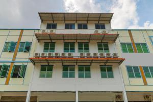 a building with a balcony on top of it at RedDoorz Plus near Kepri Mall in Batam Center