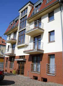 a building with balconies on the side of it at Hotel Aleksander in Ustka