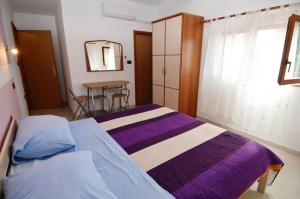 a bedroom with two beds and a table and a mirror at Mon Perin Castrum - Rooms Dado in Bale +35 photos