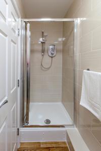 a bathroom with a shower with a glass door at Castle Point Apartments Southampton Premier Lodge in Southampton