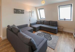 a living room with a couch and a table at Castle Point Apartments Southampton Premier Lodge in Southampton