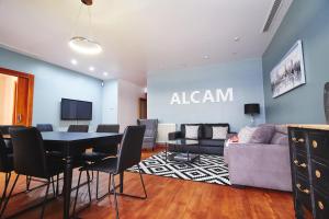 a living room with a table and a couch at Alcam Plaza Cataluña in Barcelona