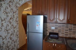 a kitchen with a stainless steel refrigerator in a kitchen at Ветеринарный in Berdychiv