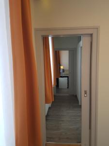 a room with a door leading to a hallway at Hotel Restaurant Ketterer am Kurgarten in Triberg