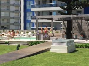 a group of people sitting around a pool in a building at Apartamento Forest 2 in Punta del Este