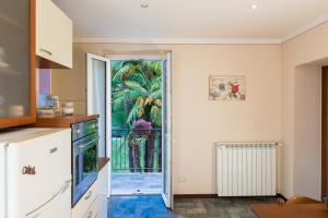 a kitchen with a door leading to a garden at Rio Molino in Stresa