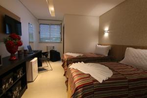 Tupyguá Brasil Hotel tesisinde bir odada yatak veya yataklar