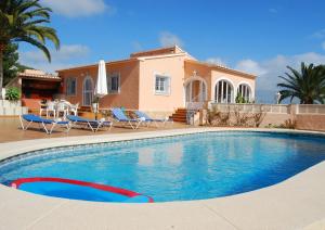 a swimming pool in front of a house at Villa Pepe in Benissa