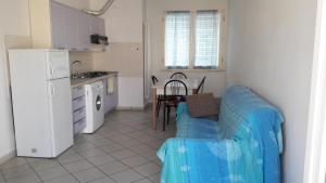 a kitchen with a couch and a table in a room at Residence Onda Blu in Cervia