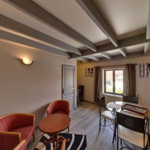 a living room with a table and chairs at Gite La Ferme du Grand Air in Fiennes