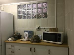 a kitchen with a microwave on a counter at Geranium Studio in Somerset West