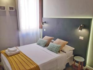 a bedroom with a large bed with two pillows on it at RomExperience Borgo Pio in Rome