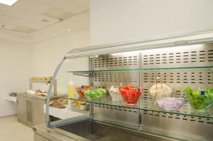 a kitchen with a counter with bowls of food at Regina Goren Hotel in Ashqelon