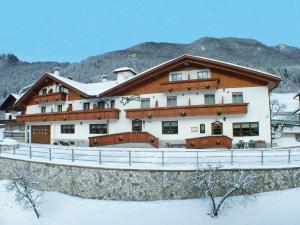 a large building with snow on the ground at Hotel Al Sole in Tarvisio