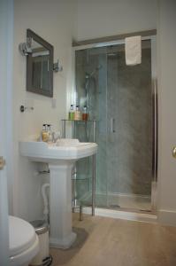 a bathroom with a sink and a shower at Lubnaig Guest House in Callander +141 photos