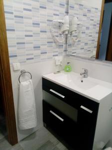 a bathroom with a sink and a mirror at Casa Rural Las Mestas in Cangas del Narcea