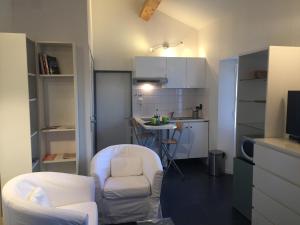 a small kitchen with two chairs and a table at Charmant Studio Brignoles in Brignoles