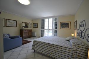 a bedroom with a bed and a chair in a room at Appartamento Valentina in Cortona +24 photos