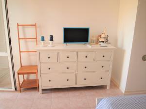 a dresser with a television on top of it at Studio Apartment Branko in Novalja