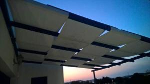 awning on a building with the sunset in the background at Vigles in Adamantas