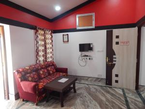 a living room with a couch and a basketball hoop on the wall at Asian Grand Villa in Bolpur