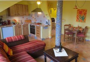 a kitchen and living room with a couch and a table at Försters Weinterrassen in Bad Neuenahr-Ahrweiler