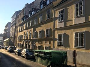 a boat parked next to a building on a street at Vienna Premium Room Naschmarkt II in Vienna