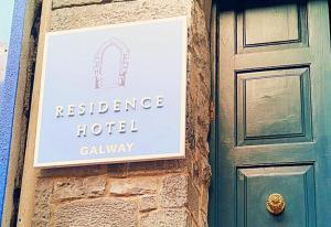 a sign for a residence hotel next to a door at The Residence Hotel in Galway
