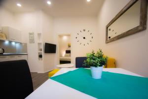 a room with a table and a clock on the wall at Apartment Mia in Budva