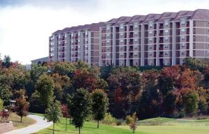 a large building with trees in front of it at Grand Crowne Resort by Capital Vacations in Branson