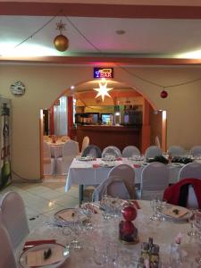 un comedor con mesas blancas y sillas blancas en Motel Topolog, en Râmnicu Vâlcea