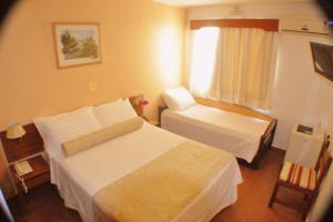 A bed or beds in a room at Hotel Torremolinos