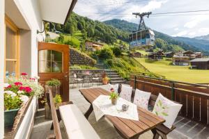 a balcony with a table and chairs and a ski lift at Hotel-Pension Faneskla in Silbertal
