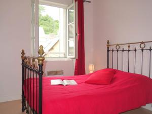 a bedroom with a bed with a red blanket and a window at Apartment Le Vieux Port by Interhome in Cancale