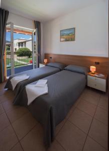Ένα ή περισσότερα κρεβάτια σε δωμάτιο στο Residence Corte Delle Rose